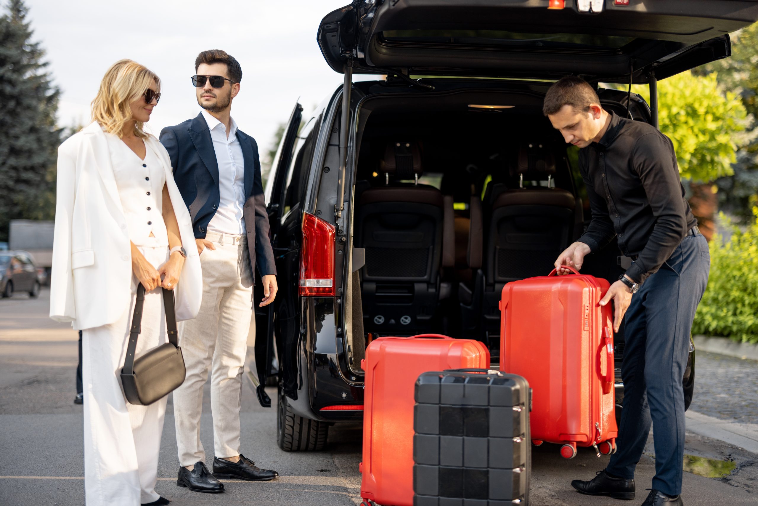 Business,Couple,Standing,By,A,Minivan,Taxi,Waiting,For,Their