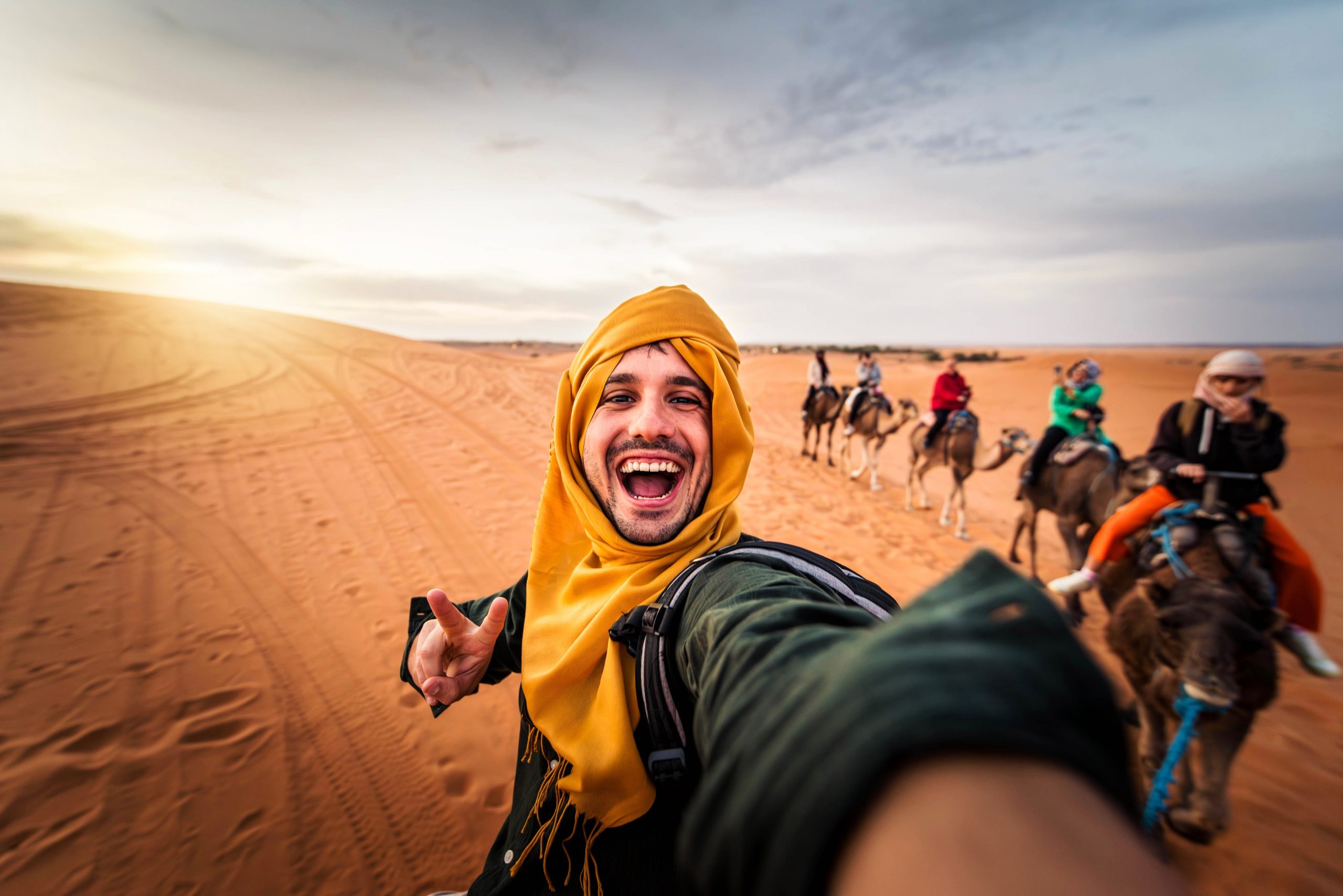 Happy,Tourist,Having,Fun,Enjoying,Group,Camel,Ride,Tour,In